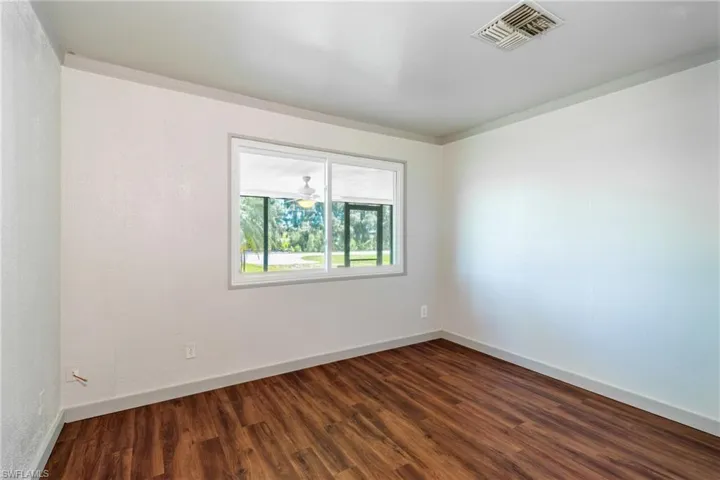 Unfurnished room with hardwood / wood-style floors