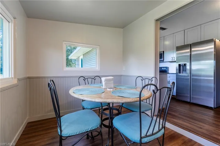 Dining space featuring plenty of natural light and dark hardwood / wood-style floors