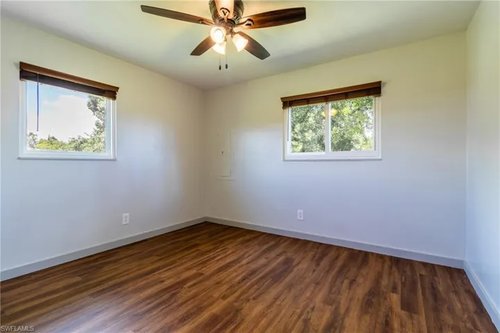 Spare room with ceiling fan and dark hardwood / wood-style flooring