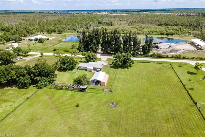 Drone / aerial view with a water view and a rural view
