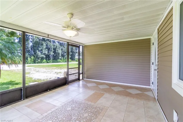 Unfurnished sunroom with ceiling fan