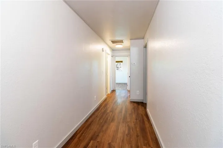 Hall featuring dark hardwood / wood-style flooring