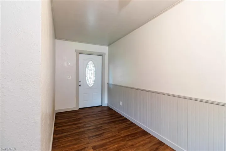 Foyer entrance with dark hardwood / wood-style floors