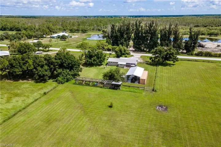 Drone / aerial view with a water view and a rural view