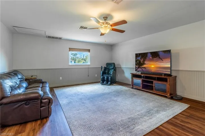 Living room featuring ceiling fan and wood-type flooring