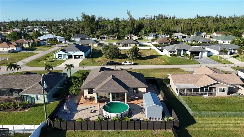 Aerial view of residential area featuring a pool