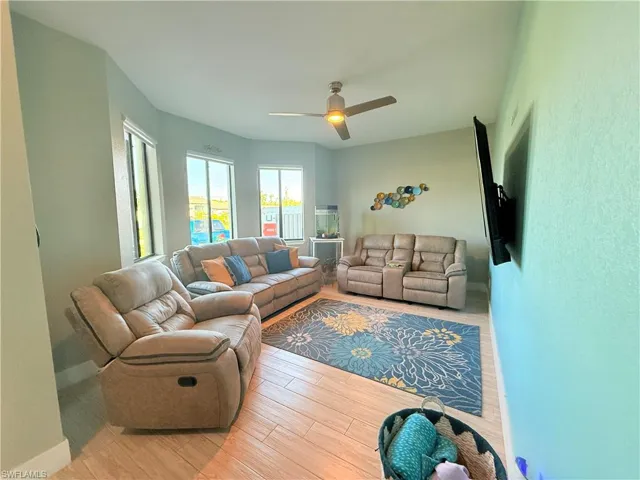 Living area with wood finished floors and a ceiling fan