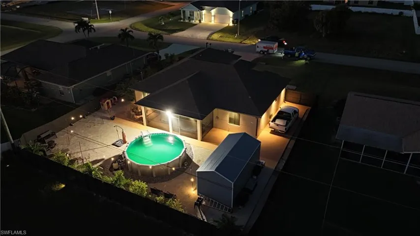 View of subject property with a pool area
