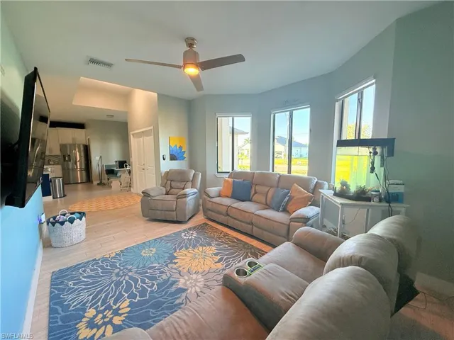 Living room featuring light wood finished floors and ceiling fan