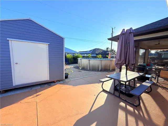 View of patio featuring a covered pool and outdoor dining area