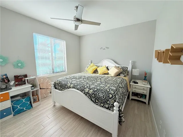 Bedroom with wood finished floors and ceiling fan