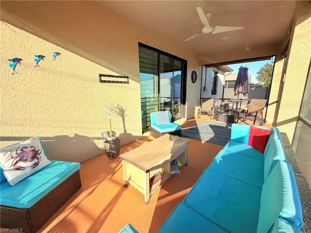 View of patio featuring an outdoor living space and a ceiling fan