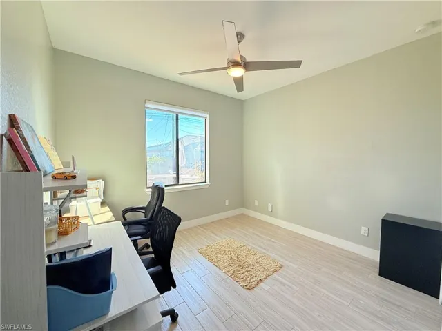 Office space featuring light wood-style floors and a ceiling fan