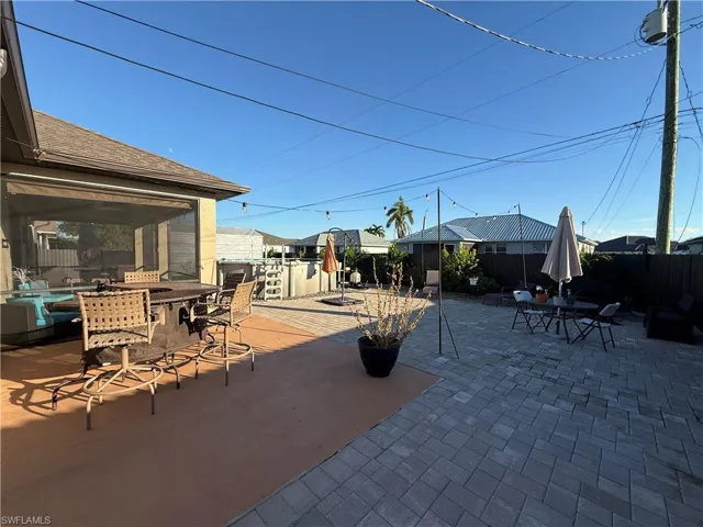 Fenced backyard with outdoor dining space and a patio