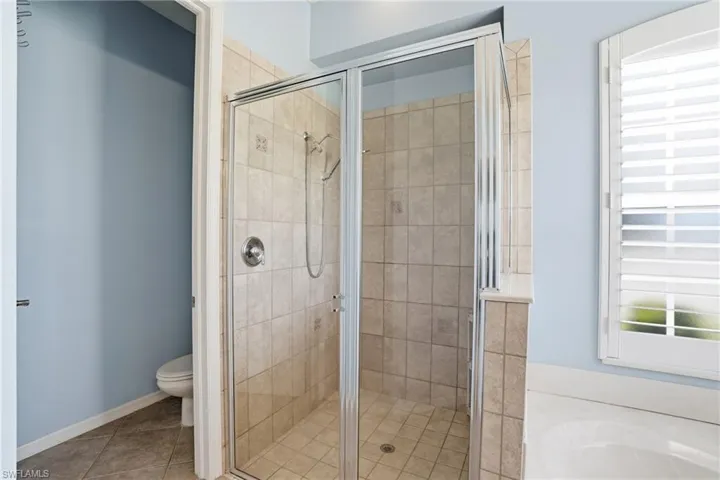 Glass-enclosed shower with a tiled surround