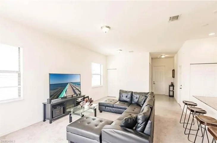 Living area with light colored carpet