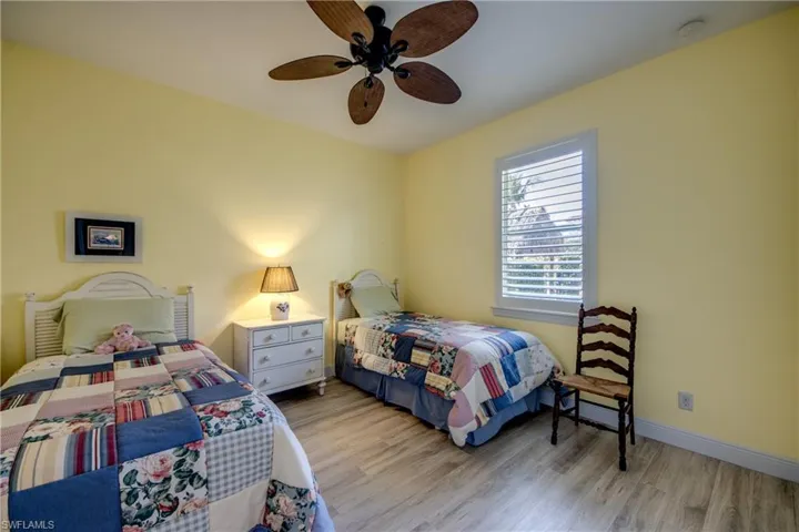 Bedroom with light wood-style floors and a ceiling fan