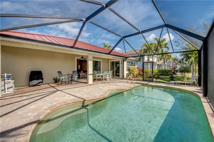 Swimming pool with outdoor dining space, a lanai, a patio area, and a sunroom