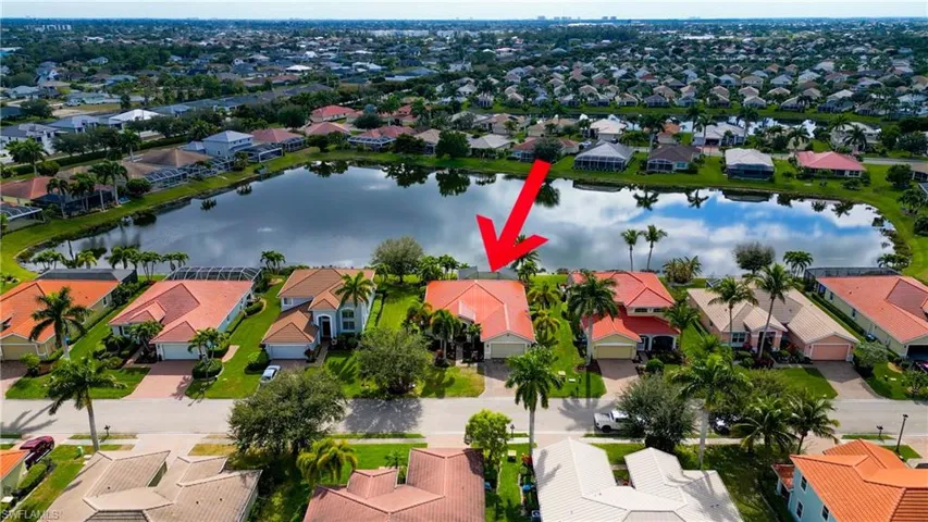 Aerial view of property and surrounding area with nearby suburban area