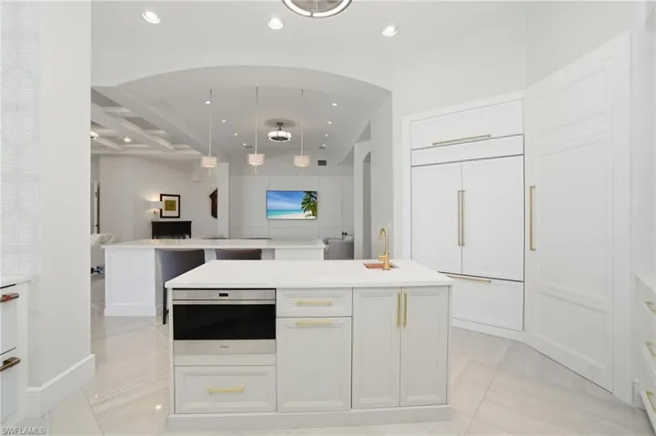 Walk-in pantry, a nearby air-conditioned wine room plus a separate 300-bottle dual zone wine fridge, 48-inch Sub Zero refrigerator, 48 inch Wolf gas range with 30 & 18 inch ovens, Wolf microwave & GE Cafe dual dishwasher drawers & dual refrigerator drawers.
