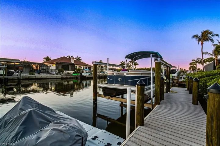 Ideal for beach lovers & boating enthusiasts, this stunning coastal home is just 5 minutes away from Barefoot Beach/Bonita Beach & offers easy Gulf access from your zero-maintenance Tandek boat dock & 2023 new 10,000 lb boat lift (through Wiggins Pass or New Pass).