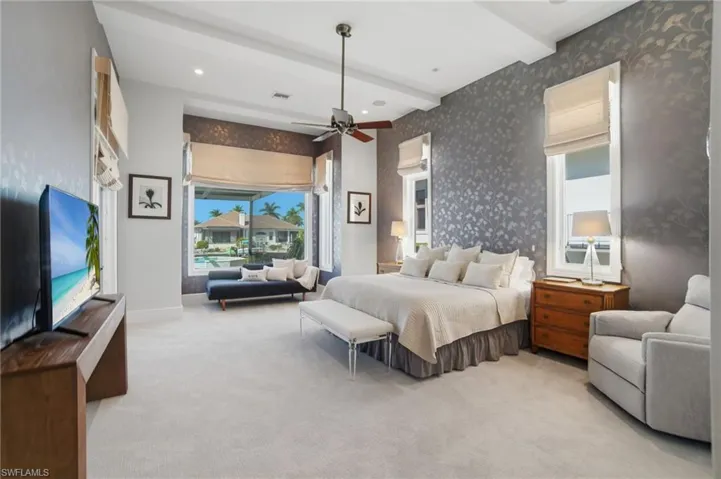 Expansive primary suite is the ultimate private oasis with a sitting area, access to the lanai, large walk-in closet with California style built-ins & a brand newly renovated spa-like bathroom with dual vanities, modern freestanding tub, large walk-in shower & Newport Brass finishes.
