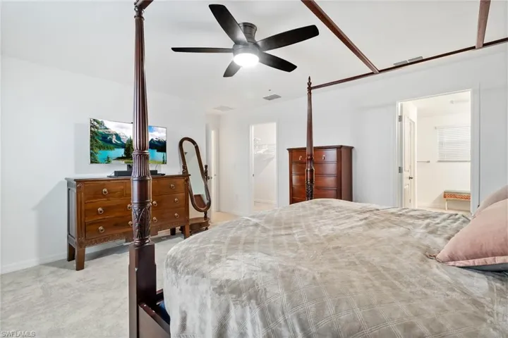 Bedroom featuring light gray carpet flooring and white walls