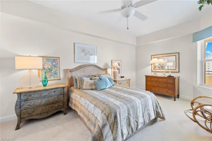 Bedroom with light carpet and ceiling fan