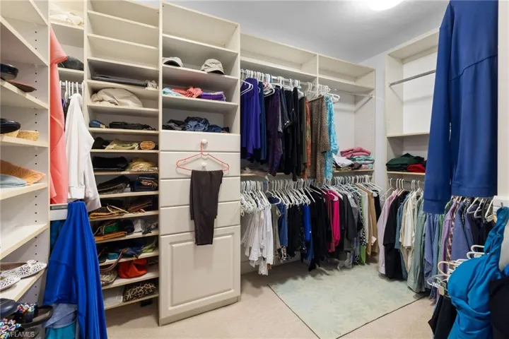 Walk in closet with light carpet