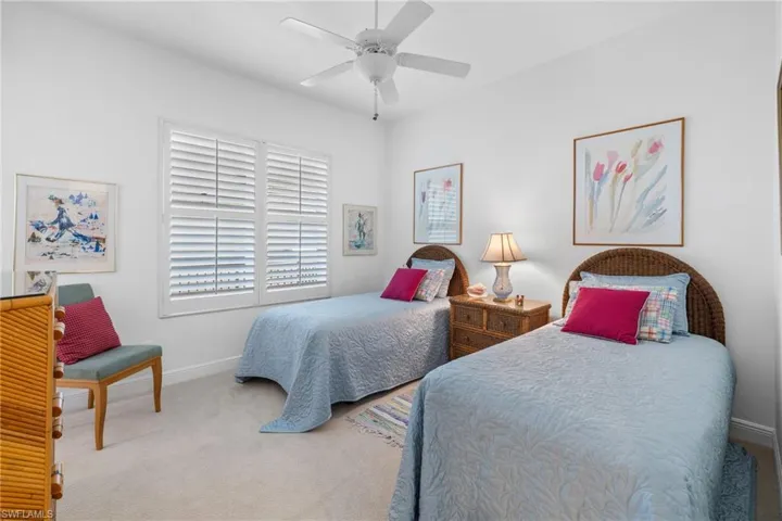 Carpeted bedroom with baseboards and ceiling fan