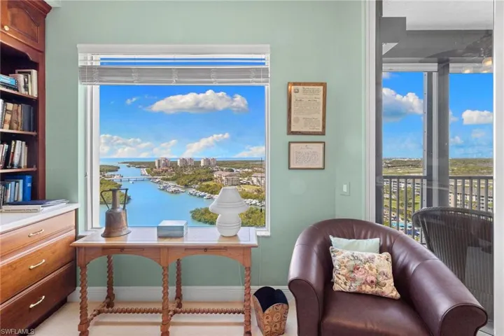 Living area with a water view and a view of city