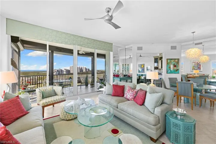 Living room featuring light tile patterned floors and a ceiling fan