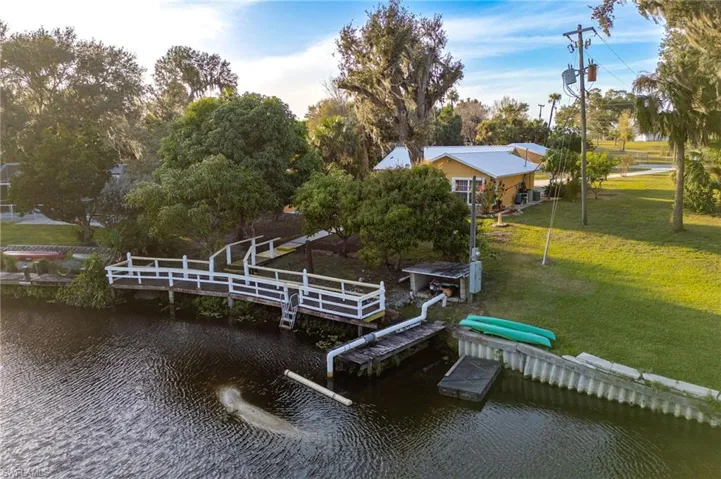 Dock area with a lawn and a water view