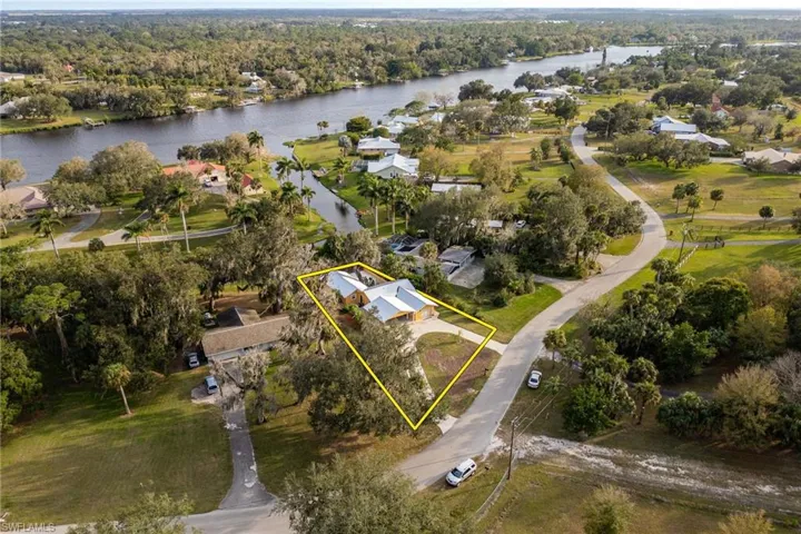 Birds eye view of property with a water view