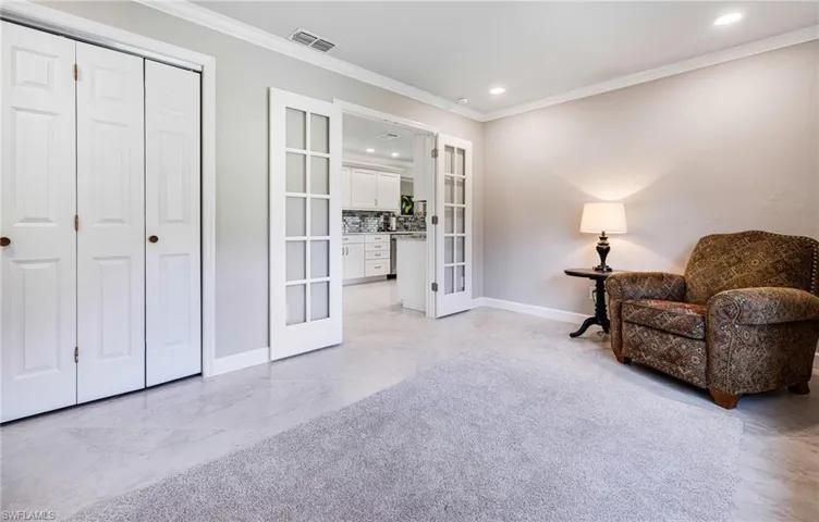 Living area featuring french doors and ornamental molding