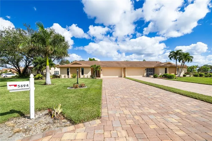 Ranch-style home featuring a garage and a front yard