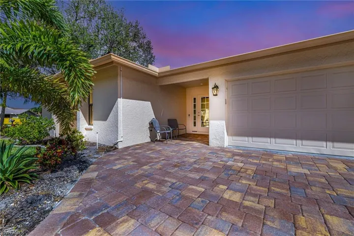 Exterior entry at dusk featuring a garage