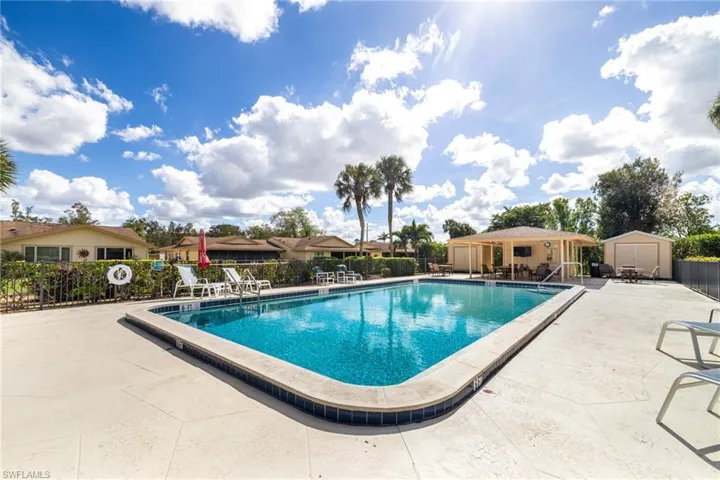 View of swimming pool with a patio area and a shed