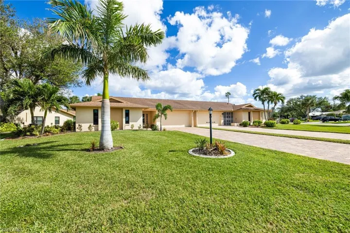 Ranch-style home featuring a garage and a front yard
