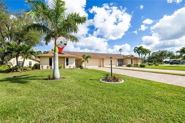 Single story home with a garage and a front yard