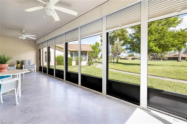Unfurnished sunroom featuring ceiling fan