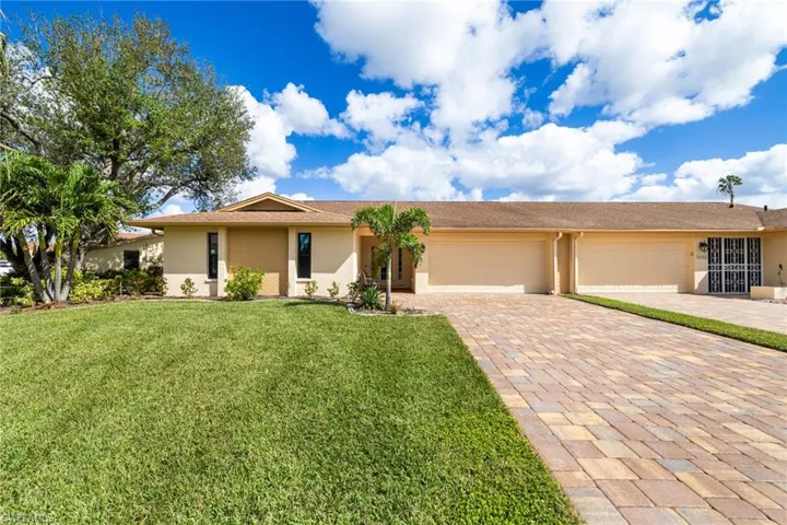 Ranch-style house with a front lawn and a garage