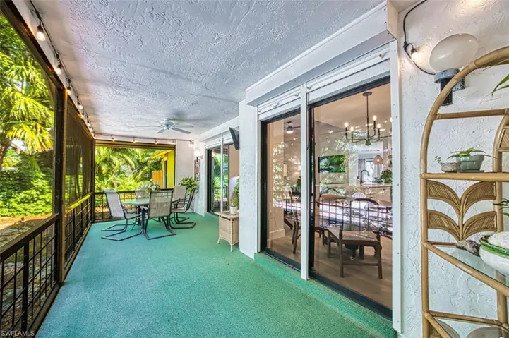 Sunroom featuring a ceiling fan and outdoor dining space