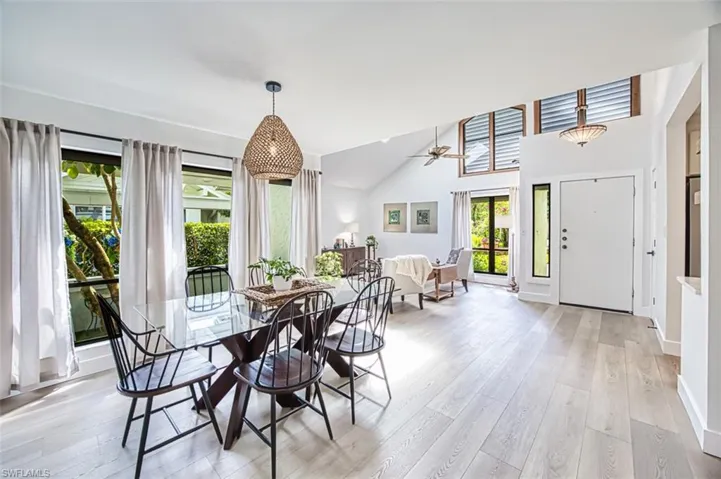 Dining room featuring healthy amount of natural light, light wood-style floors, and ceiling fan