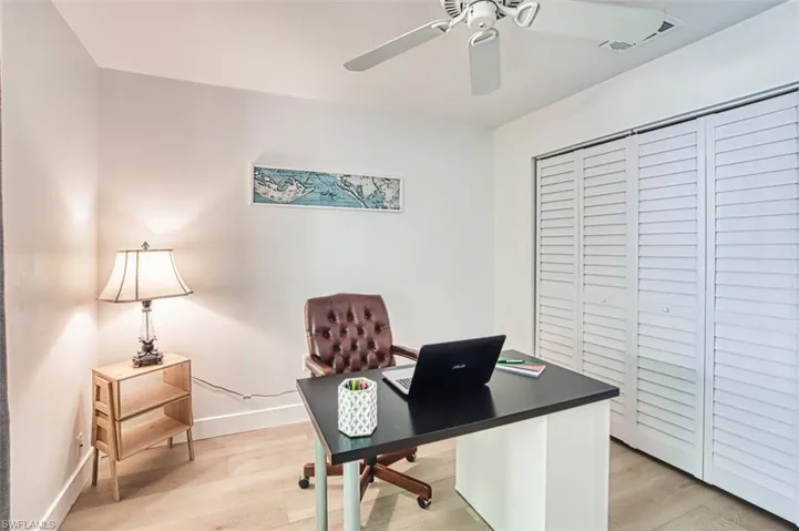 Office area with ceiling fan, light wood-style floors, and baseboards