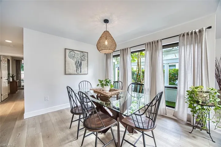 Dining area with light wood-style flooring and baseboards