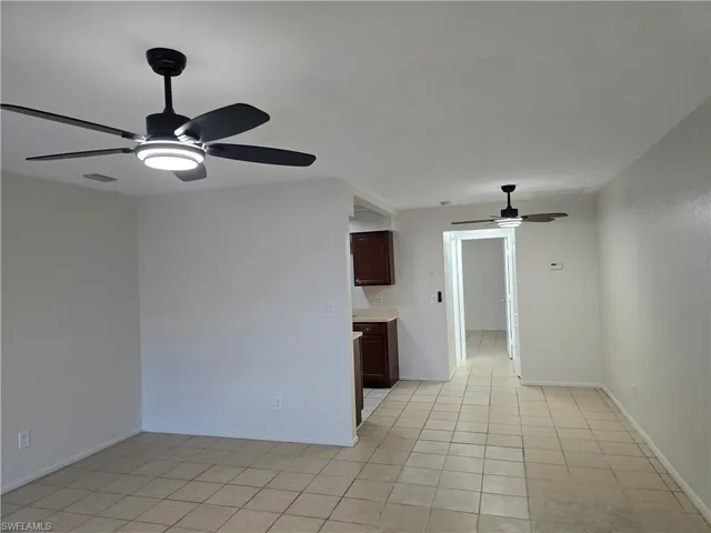Unfurnished room featuring a ceiling fan and light tile patterned floors