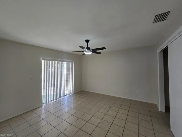 Spare room with light tile patterned flooring and ceiling fan