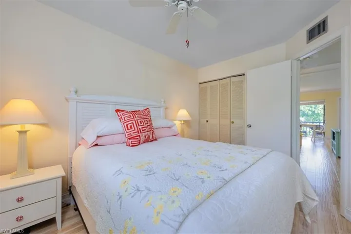 Bedroom with light wood-style floors, a closet, and ceiling fan