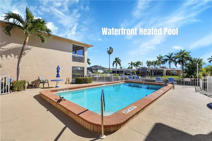 Sunny patio and palm trees surround the heated pool.